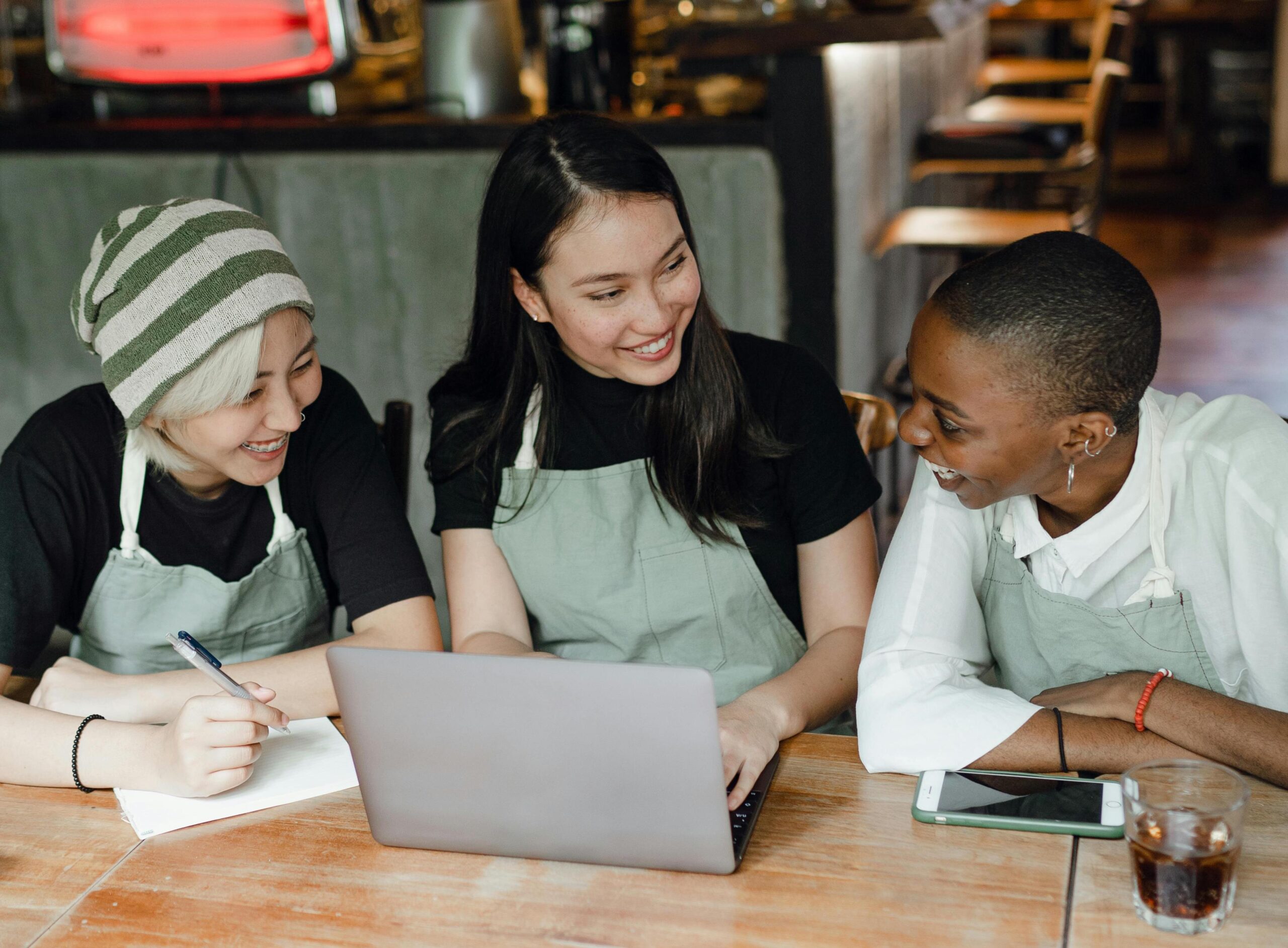 Restaurant owners looking at a computer and smiling