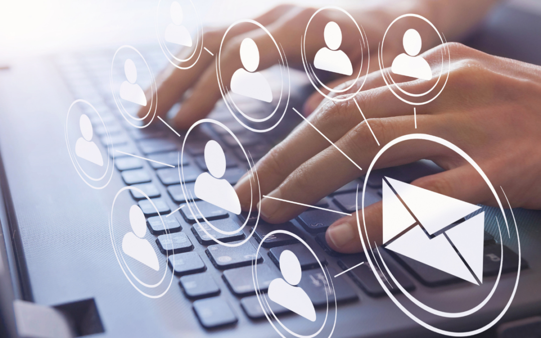 Image of hands typing on a computer and sending emails